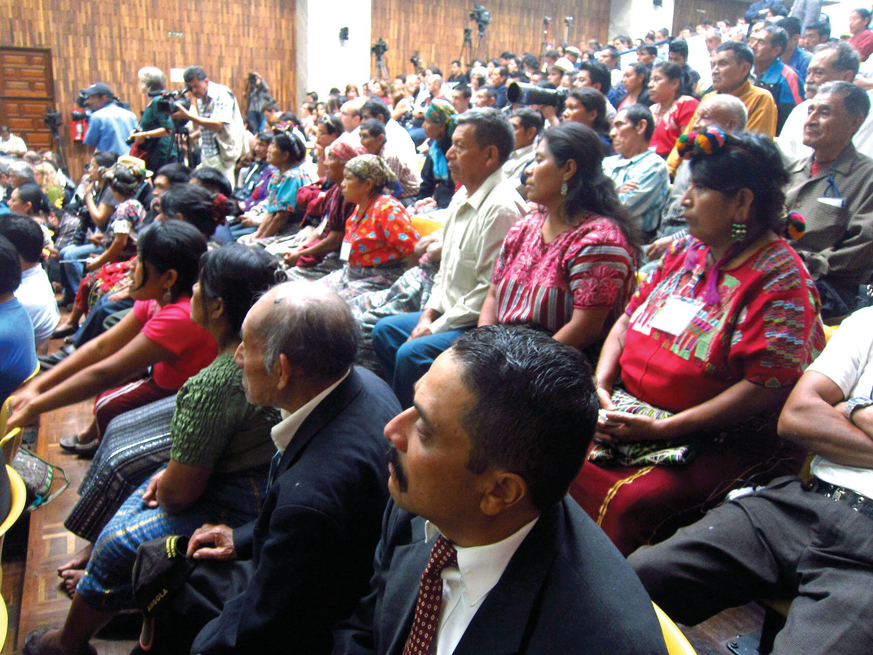 The Guatemalan courtroom audience, in a mixture of Indigenous and formal dress, watches the Ríos Montt trial proceed. (Photo by Anthony Fontes.)