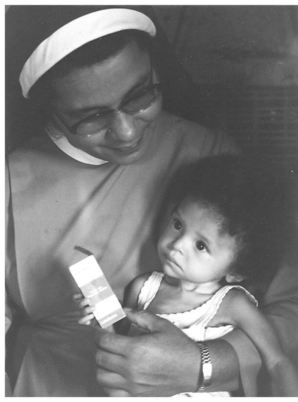 A nun rescued and holds a malnourished and underweight girl, who received free tranquilizers but not food from local authorities. (Photo by Nancy Scheper-Hughes.)