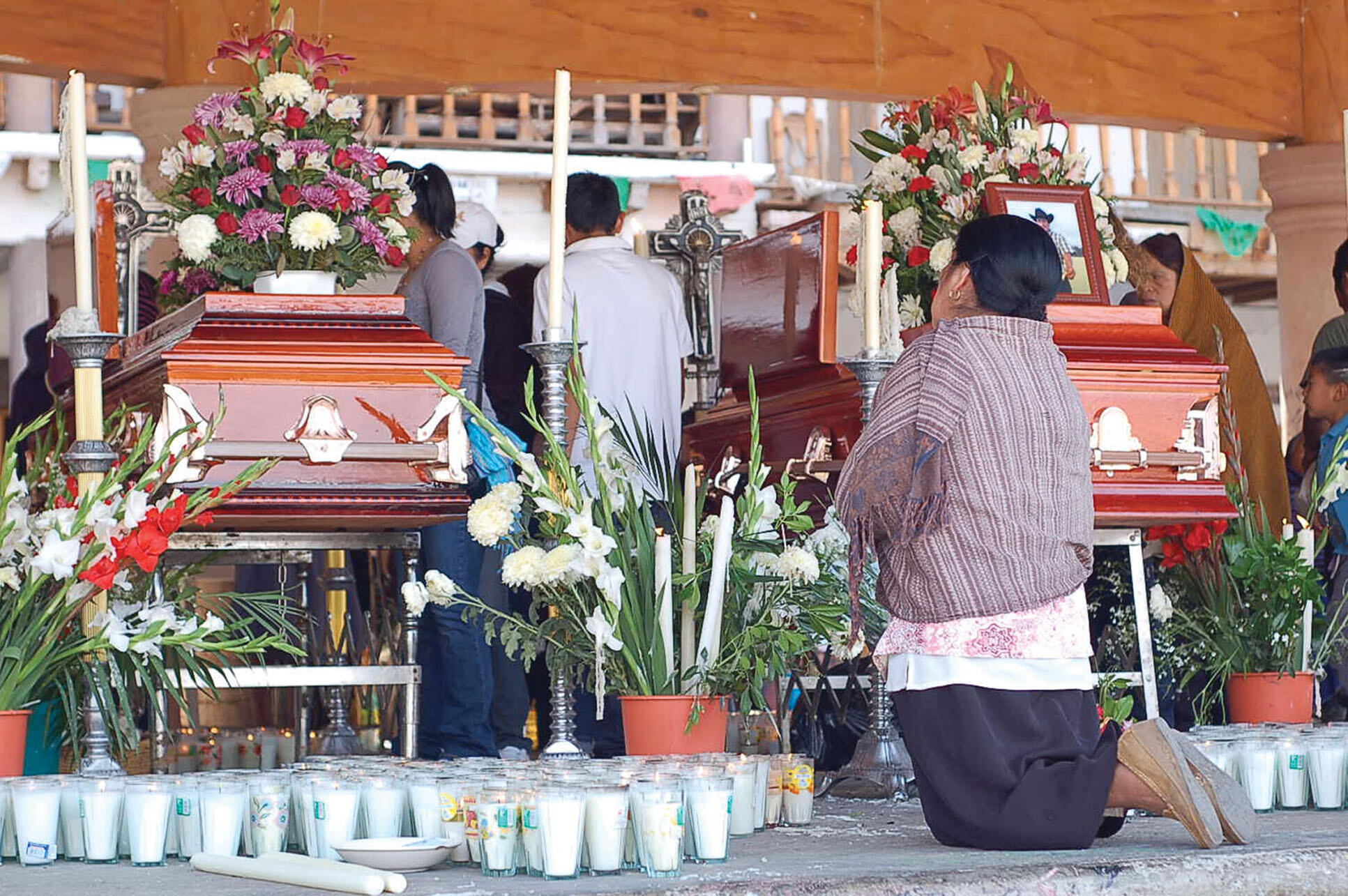 A funeral for victims of the violence in Cherán. (Photo by Juan José Estrada Serafín.) Two coffins at a funeral for victims of the violence in Cherán, Mexico. (Photo by Juan José Estrada Serafín.)