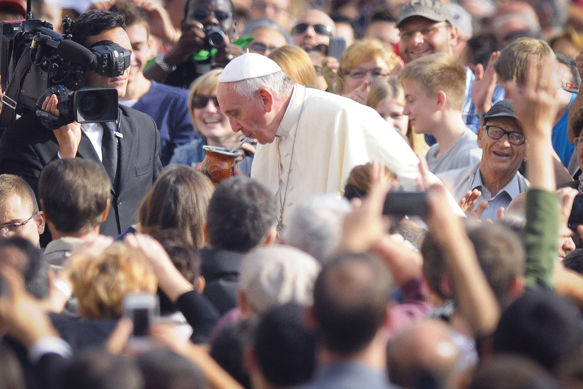 Pope Francis sips from a mug of mate offered by a pilgrim in St. Peter’s Square. (Photo from Associated Press.)