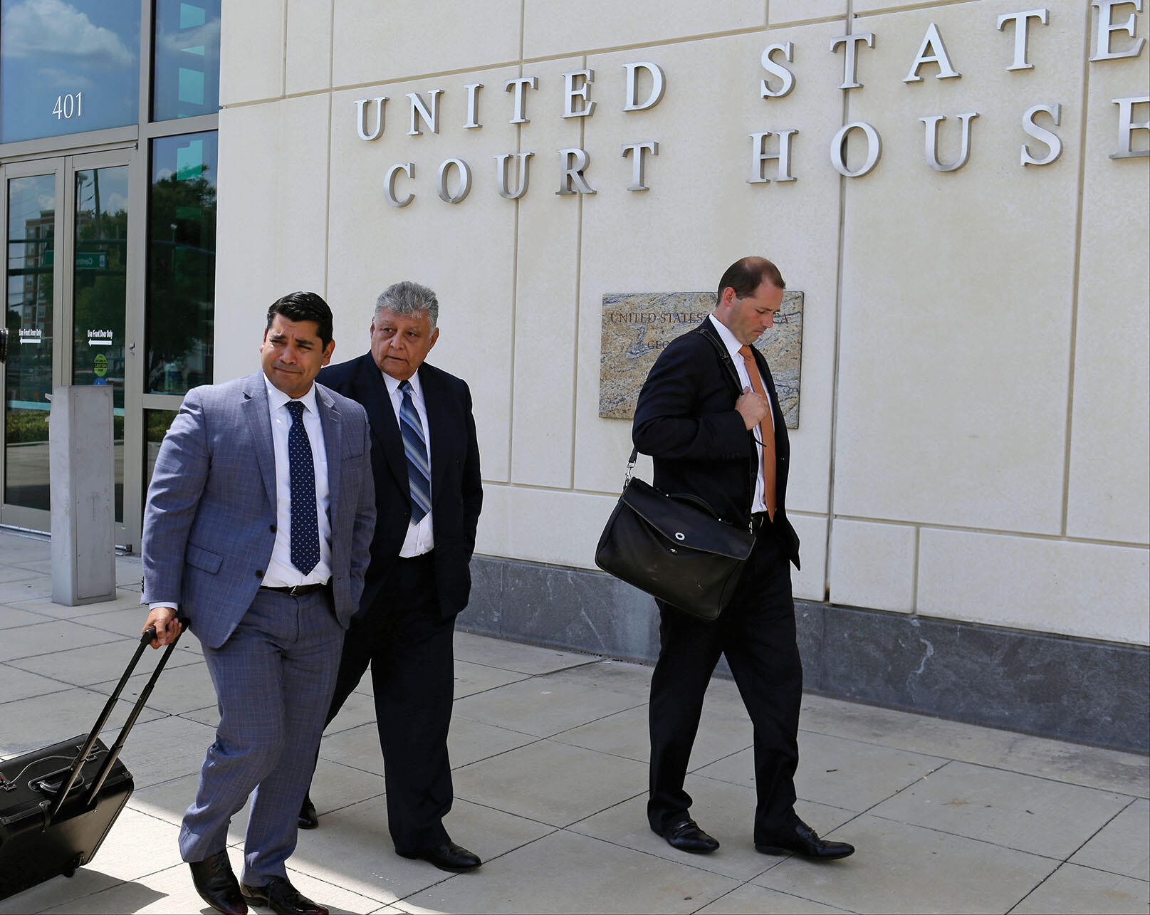 Pedro Pablo Barrientos Nuñez walks with his lawyers at the U.S. District Court, June 2016. (Photo by John Raoux/Associated Press.)