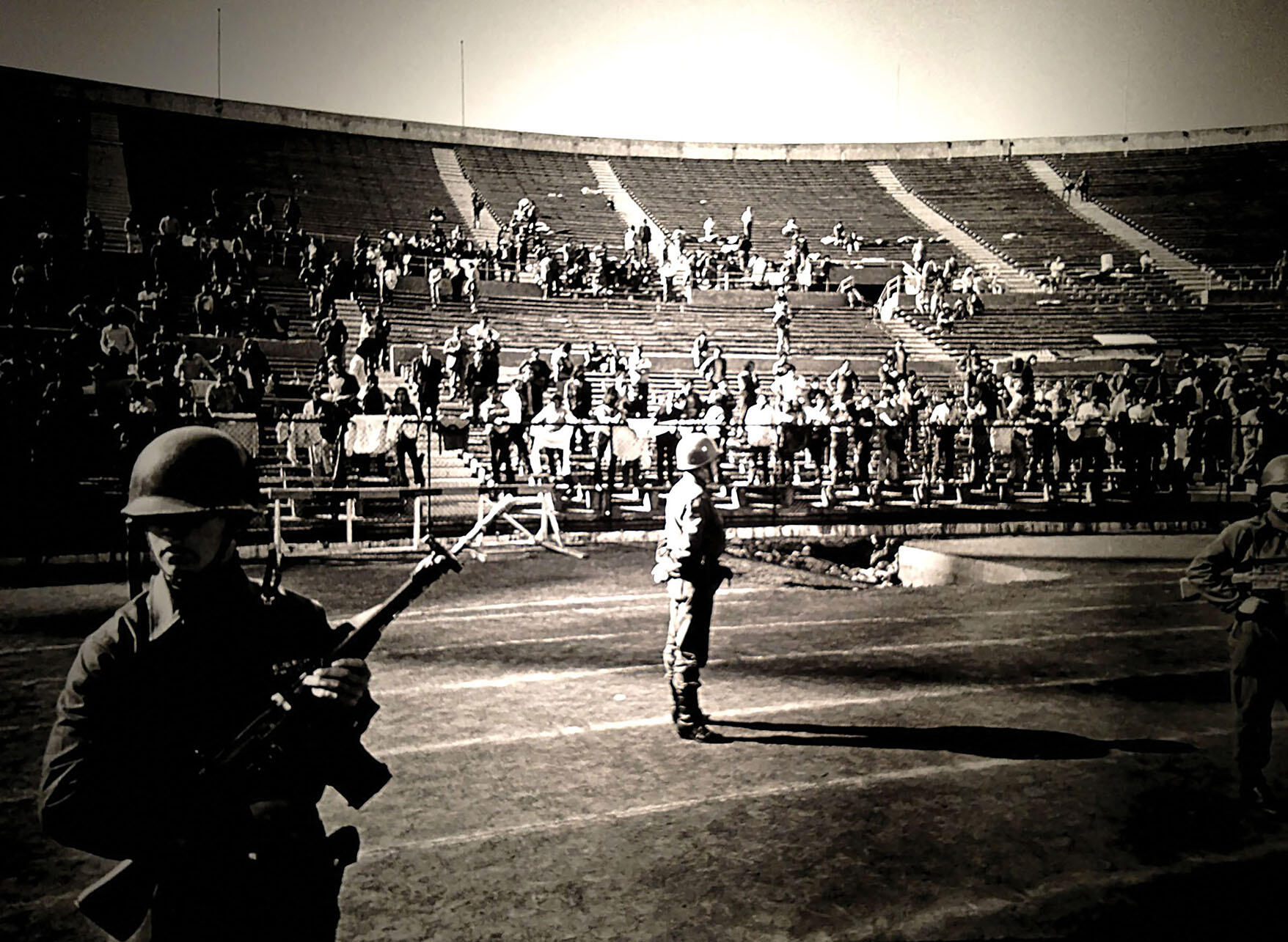 Crowds of people in the stands guarded by soldiers inside the Estadio Nacional during the coup in 1973. (Photo from El Sol, Argentina.)