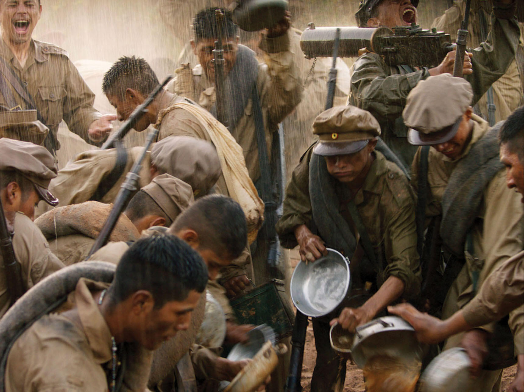 A still from “Chaco” shows soldiers’ delirium and euphoria when it finally rains — no one knows how to quench their thirst. (Image courtesy of Color_Monster, Pasto, and Murillo Cine.)
