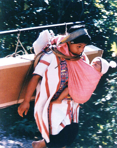 A Mayan woman carrying her child and a box of solar panels in Chiapas, Mexico. Stan ended all of his presentations with this slide. (Photo courtesy of Stan Ovshinsky.)