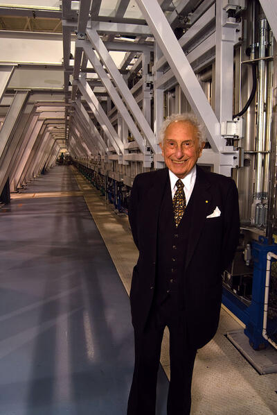 Stan Ovshinsky with his “printing press,” which produced flexible solar materials by the mile. (Photo by Brendan Ross.) Stan Ovshinsky with his “printing press,” which produced flexible solar materials by the mile. (Photo by Brendan Ross.)