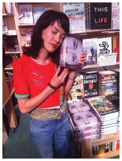 Katrina Dodson stands in a bookstore after a signing with the Complete Stories by Clarice Lispector. (Photo by Stephen Sparks.)