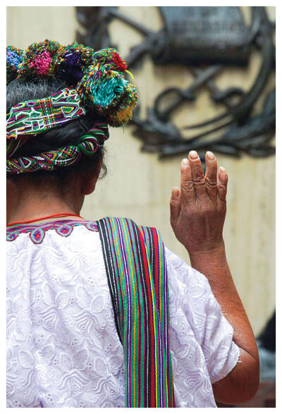 A Mayan woman in traditional dress stands to be sworn in as she testifies at the trial of Efraín Ríos Montt in Guatemala. (Photo by trocalre.)